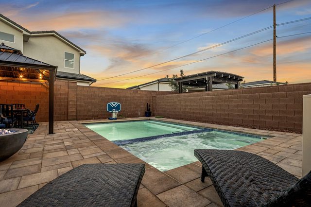 Private pool and hot tub at twilight with lounge chairs