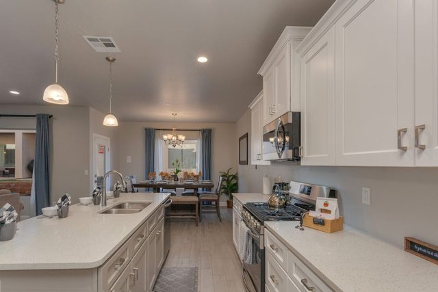 Kitchen counters and gas range looking toward the dining table