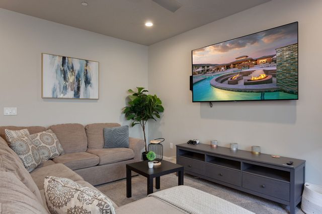 Living room sectional facing a large wall-mounted TV