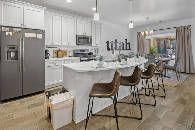 Kitchen island with bar stools and stainless refrigerator