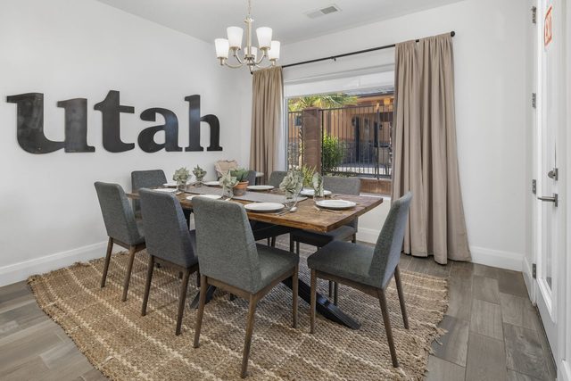 Dining table for six under chandelier at Zion Village 395