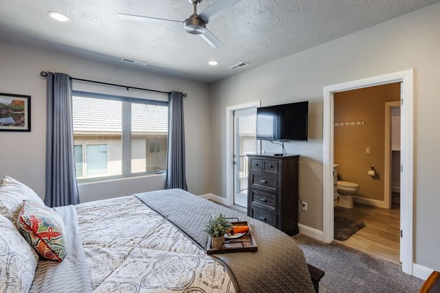 King master bedroom with TV and balcony door