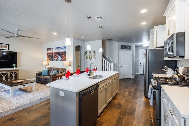 Kitchen with white cabinets, gas range and island