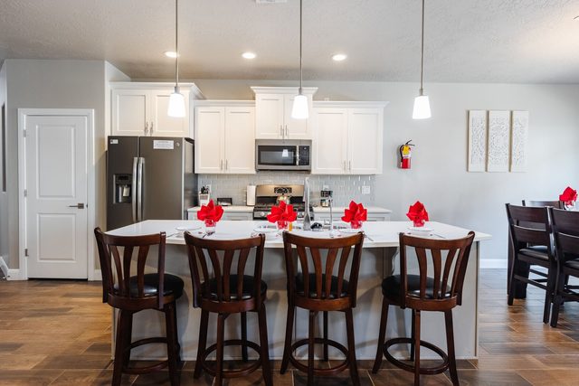 Kitchen island with four bar stools at Zion Village 415