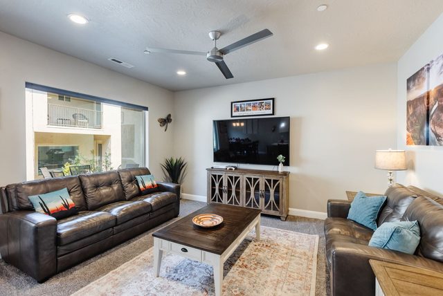 Living room leather sofas facing TV console