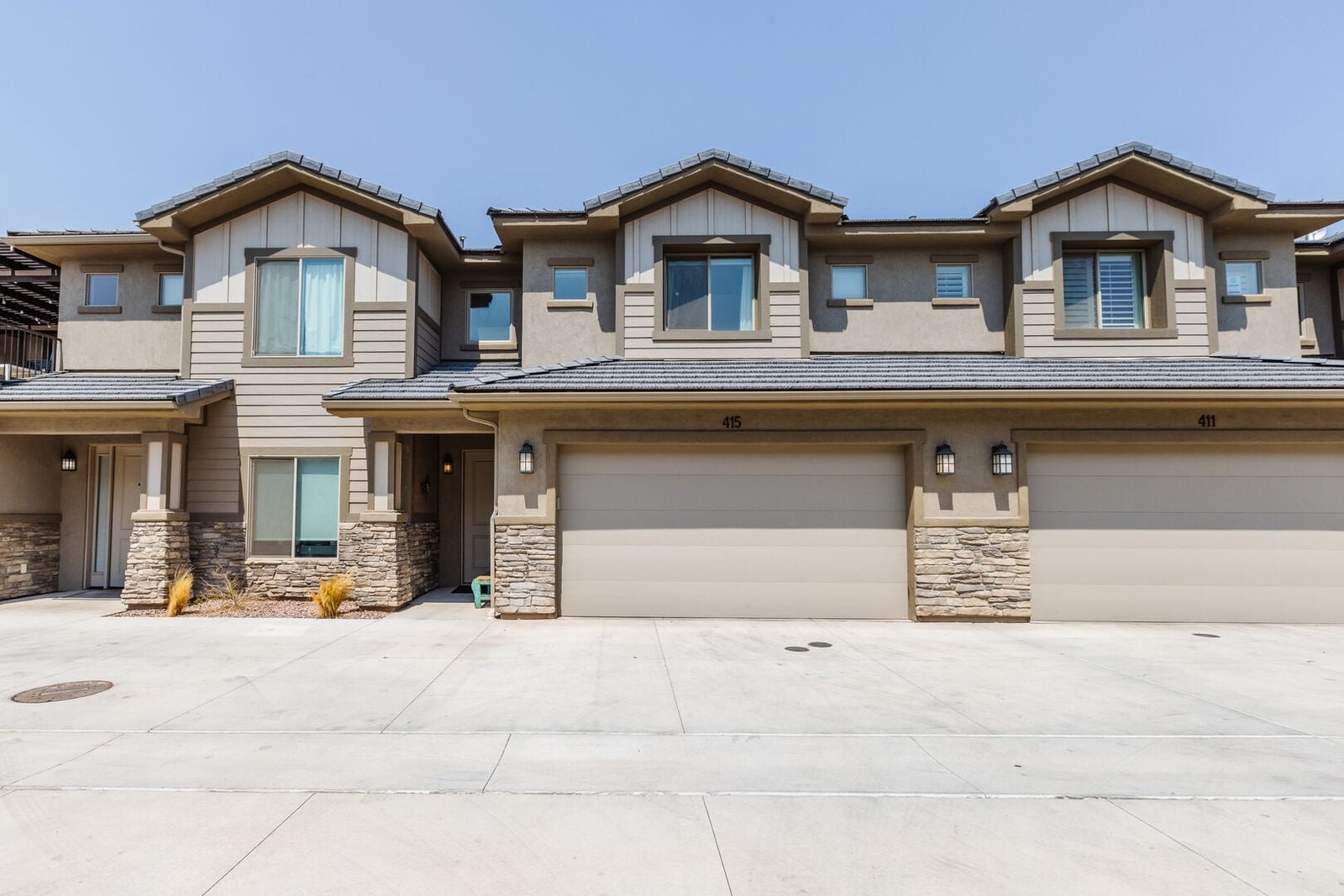 Front exterior and garages of Zion Village 415 townhome